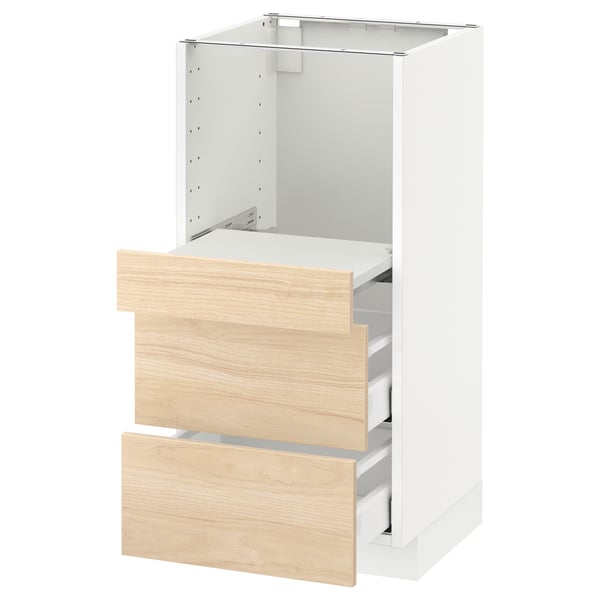 Displays a white ikea METOD kitchen cabinet with light ash wooden drawers. It two drawers and a pull-out shelf.