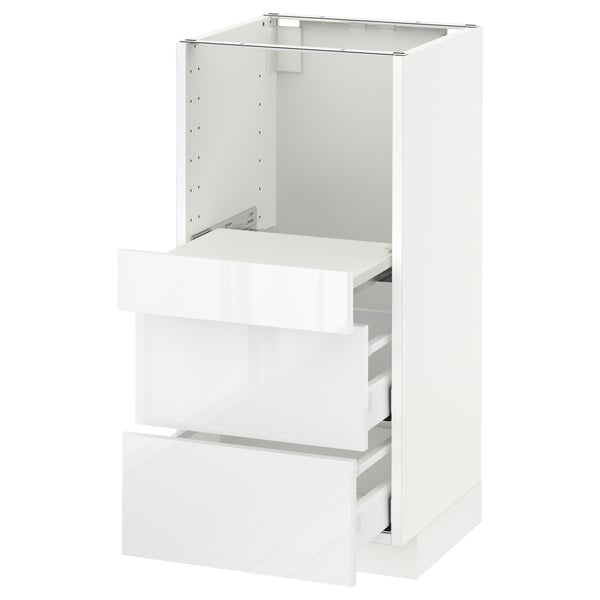 White METOD kitchen cabinet with glossy drawers and metallic frame.