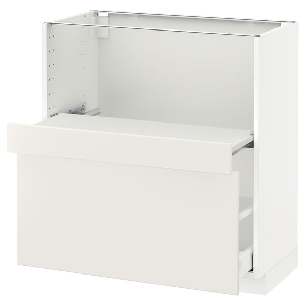 A white METOD kitchen cabinet from ikea with a smooth drawer and pull-out shelf.