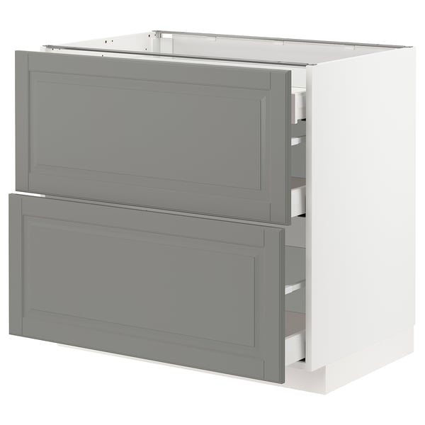 A soft grey METOD kitchen cabinet with two drawers and a door, featuring a traditional design with bevelled edges.