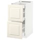 Displays an off-white METOD kitchen cabinet with bevelled edges, comprising two drawers and a door. The cabinet is rectangular with a smooth finish.