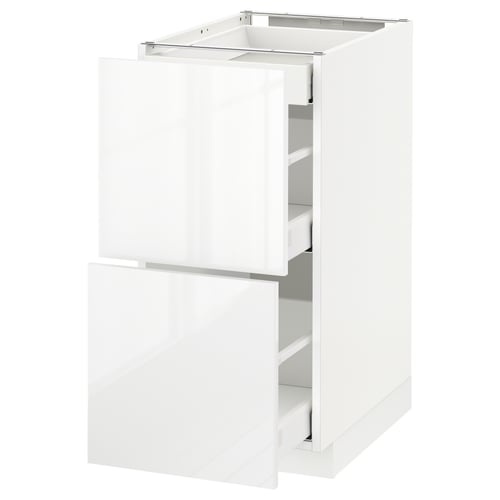 A white METOD kitchen cabinet with glossy finish, sleek design, and multiple drawers.
