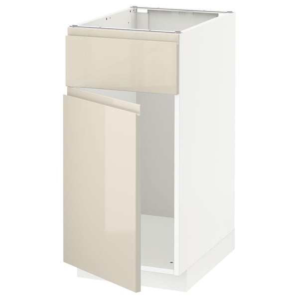 A METOD kitchen cabinet with a high-gloss beige finish, featuring a drawer and a door with integrated handles. It has a modern, sleek design.