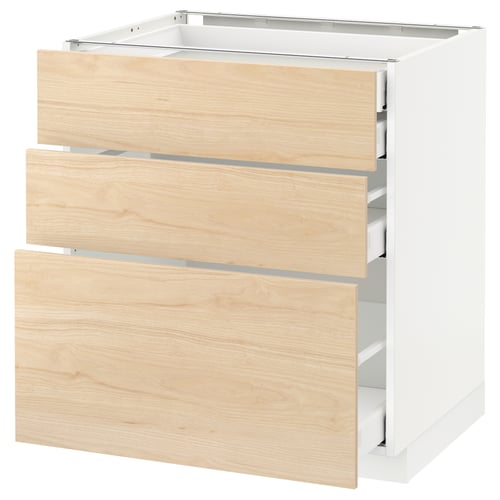 A white METOD kitchen cabinet with light ash wood-patterned drawers. It three pull-out drawers and is framed in white.