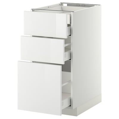 White kitchen cabinet with three open drawers, glossy finish, modern design.