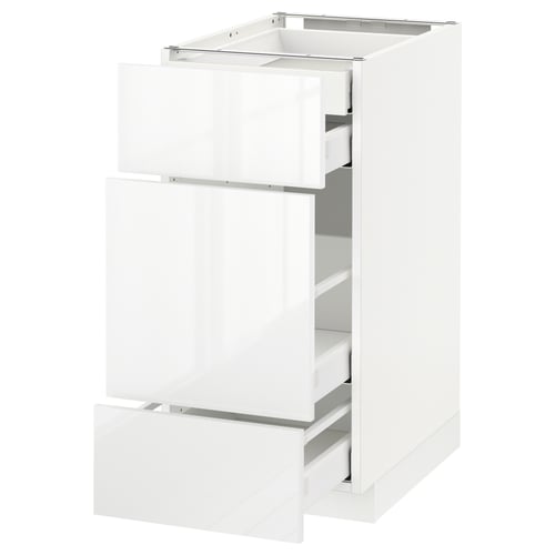 A white METOD kitchen cabinet with three open drawers. The cabinet is sleek and modern with glossy finish drawers.