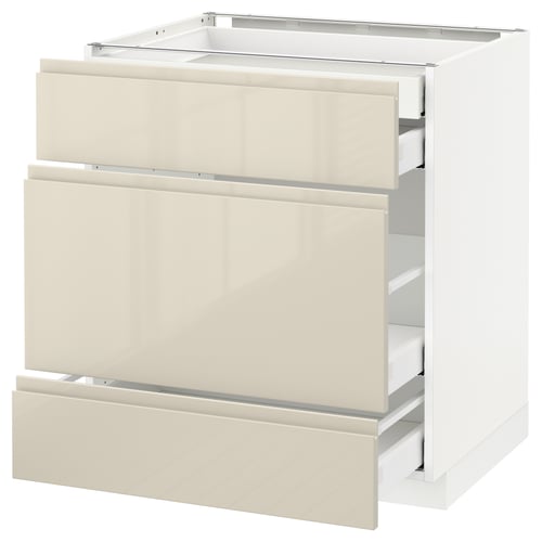 A white METOD kitchen cabinet with beige glossy drawers and integrated handles. It has three drawers, with a sleek modern design.