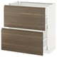 A modern kitchen cabinet. The METOD system white and dark walnut effect drawers with integrated handles. The design is sleek and minimalist.