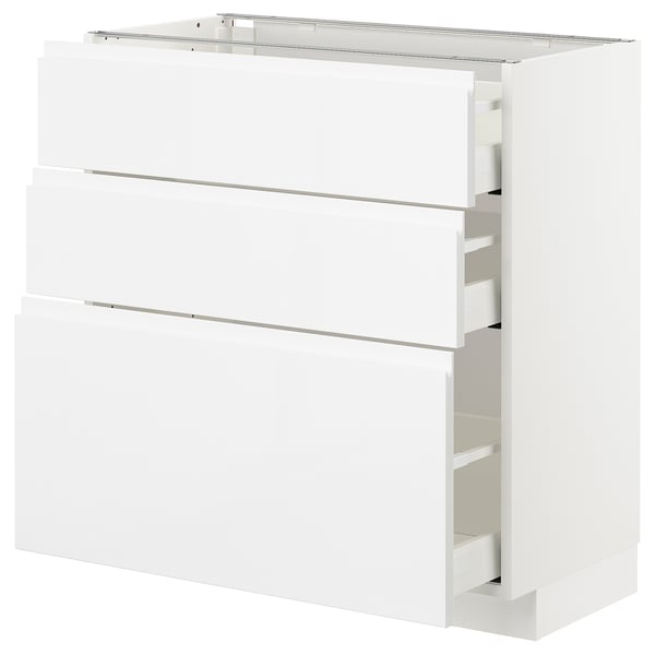 A white METOD kitchen storage unit with smooth, glossy fronts and integrated handles. It three drawers with a sleek, modern design.