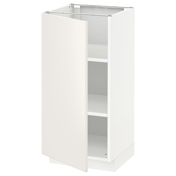 The white METOD kitchen cabinet with veddinge fronts. It has a sleek, modern design with smooth surfaces and a single, adjustable shelf.