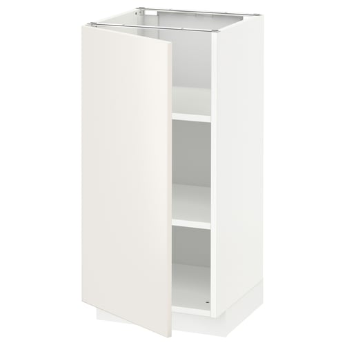 The white METOD kitchen cabinet with veddinge fronts. It has a sleek, modern design with smooth surfaces and a single, adjustable shelf.