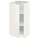 The white METOD kitchen cabinet with veddinge fronts. It has a sleek, modern design with smooth surfaces and a single, adjustable shelf.