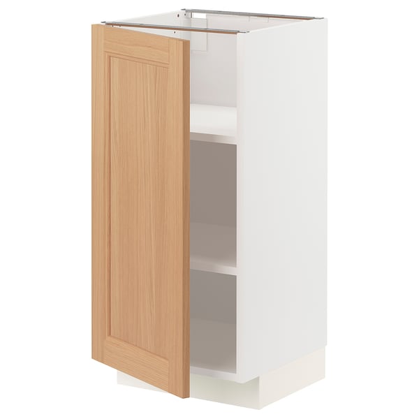 A METOD kitchen cabinet with a light oak door and white frame. It adjustable shelves and is designed for versatile kitchen organisation.