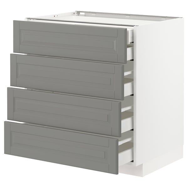 A white kitchen cabinet named METOD with four grey drawers. It has a modern design and uses wood materials.