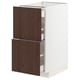 An open METOD kitchen cabinet with dark brown sinarp oak veneer drawers and a white frame.