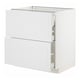White METOD kitchen cabinet with vertical grooves and opened drawers, made of particleboard and steel.