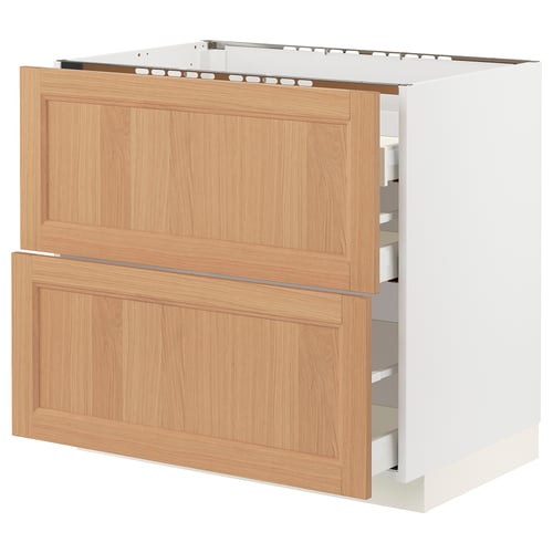 Light wooden ikea METOD kitchen unit with drawers open.