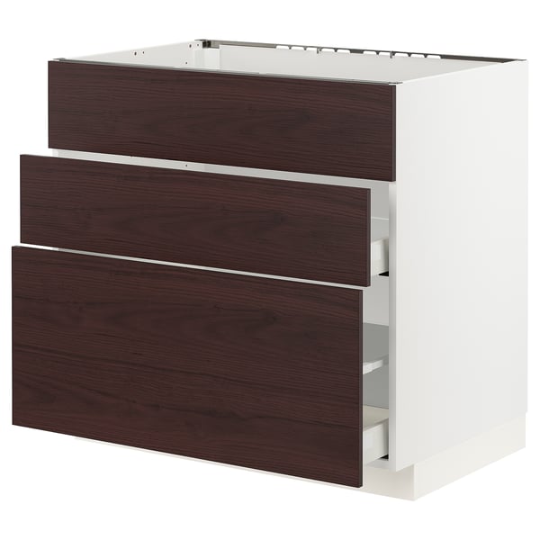 Modern kitchen unit with dark brown drawers and white base.