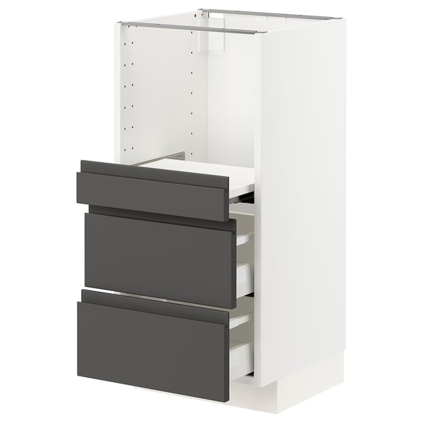An ikea METOD kitchen cabinet. It a white frame with gray drawers, boasting a sleek, modern design.