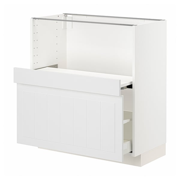 A white METOD kitchen cabinet with a wooden front, featuring a drawer and pull-out shelf.