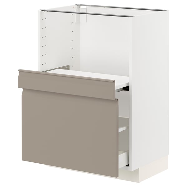 A white IKEA METOD kitchen cabinet in a modern design, equipped with grey-beige drawers and a pull-out shelf.