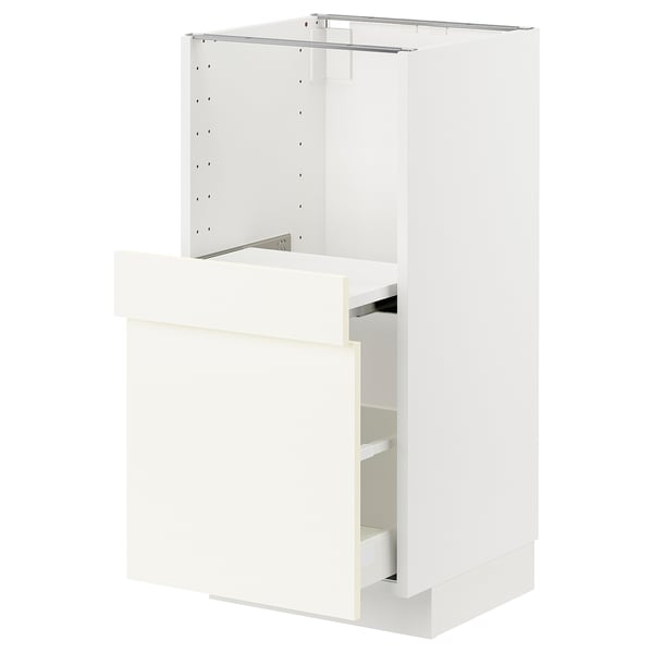 White ikea METOD kitchen cabinet with one open drawer.