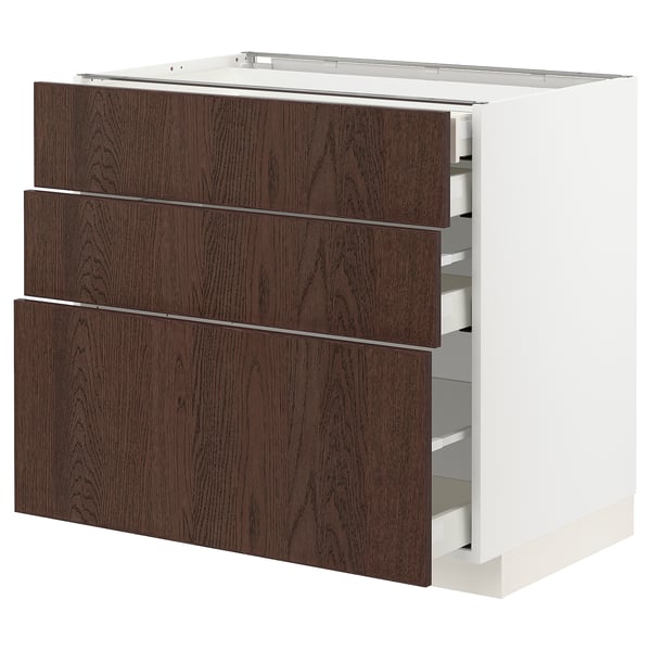 Modern white METOD kitchen unit with dark brown wood drawers, spacious and organised.