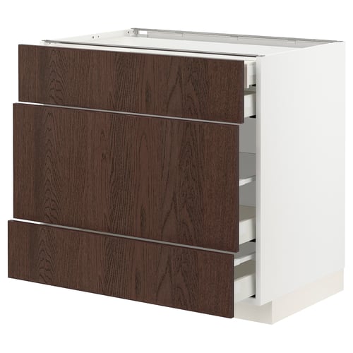 A modern kitchen cabinet named METOD with dark brown sinarp drawers featuring oak veneer and solid wood edging.