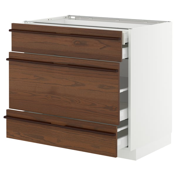 Modern kitchen unit with dark brown wooden drawers and metal handles.