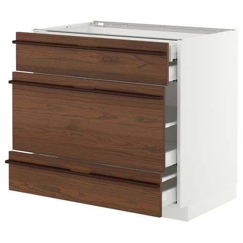 Modern kitchen unit with dark brown wooden drawers and metal handles.
