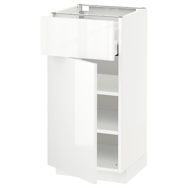 White glossy kitchen cabinet with open drawer and shelf.