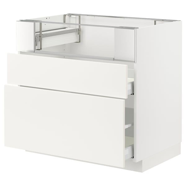 Modern white kitchen cabinet with drawers and metal hardware.
