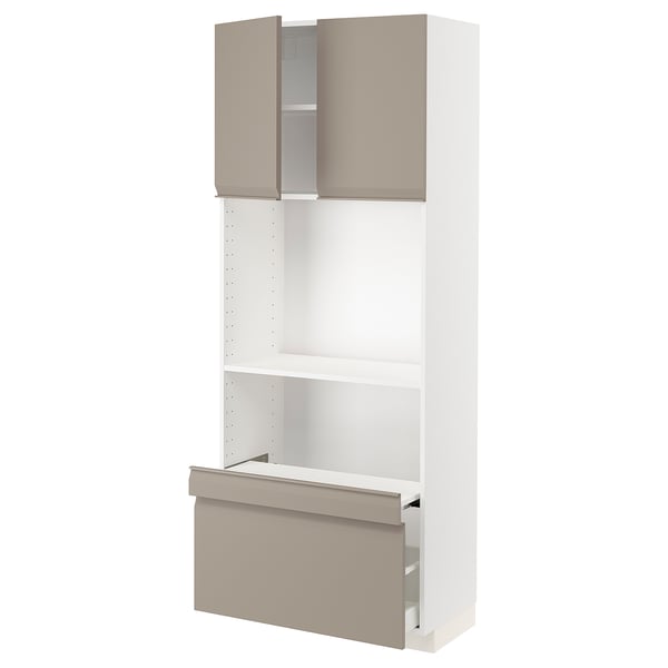 A METOD kitchen unit with grey-beige upplöv doors. It a tall, white cabinet with adjustable shelves and integrated handles.
