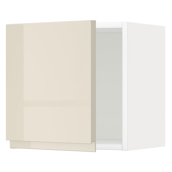 A beige high-gloss kitchen cabinet with no handles, part of the METOD system.