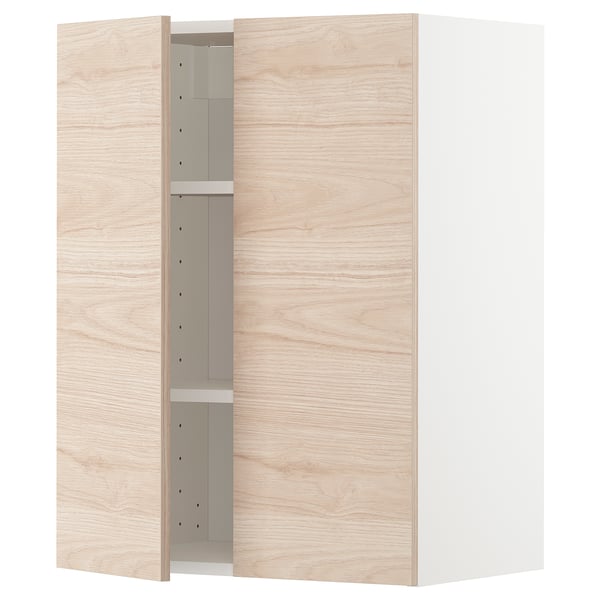 A light wood-colored METOD kitchen cabinet with an adjustable shelf and reversible doors.