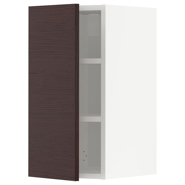 A dark brown wooden METOD kitchen cabinet with an adjustable shelf inside.