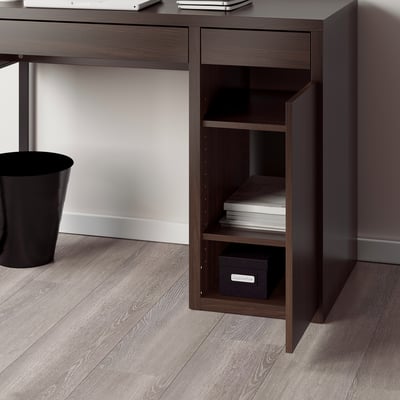 A dark brown desk with a shelf unit featuring adjustable shelves and a cable outlet, situated in a room with wooden flooring.