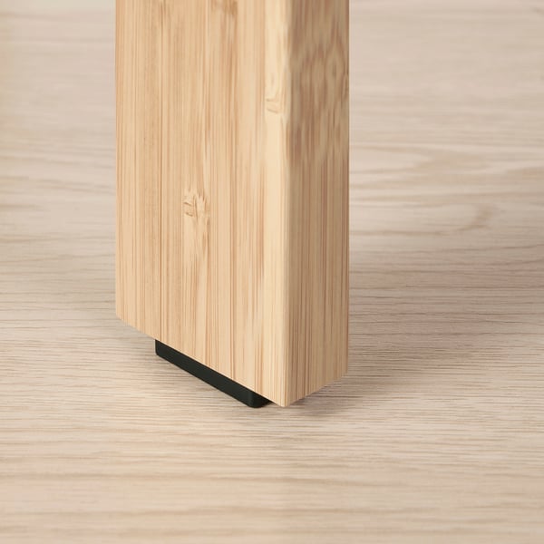 Close-up of a bamboo coffee table leg with a black metal connector, showcasing sturdy construction and smooth finish.