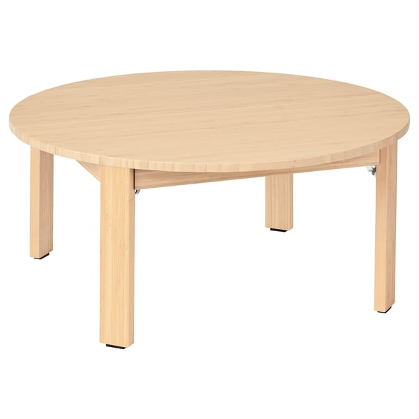 A round, light-colored MOXBODA coffee table with foldable legs made of bamboo.