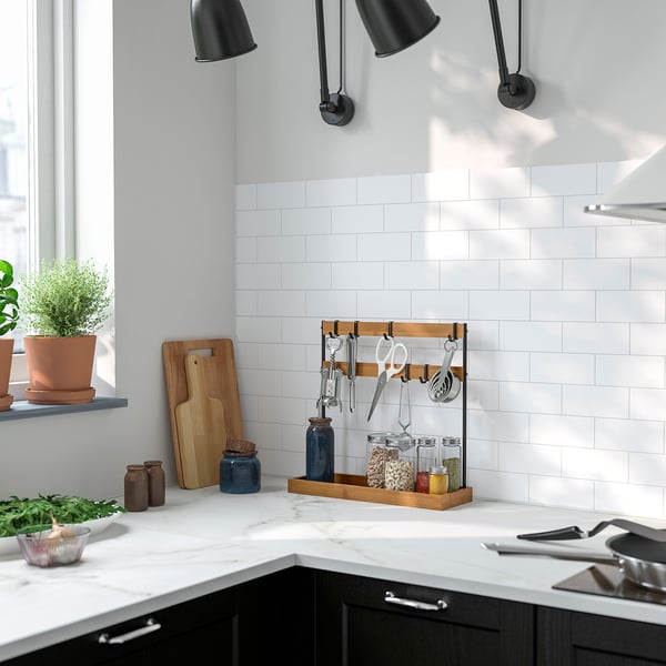 Bamboo & metal kitchen tool organiser on countertop.