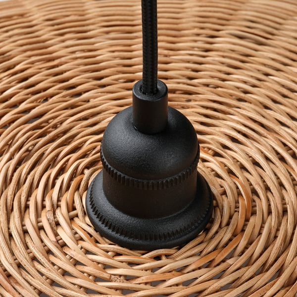 Black metal lamp base on woven surface, showcasing quality craftsmanship and design.