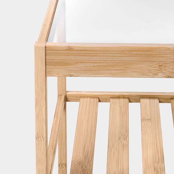 Modern bamboo side table with sturdy glass top, showcasing intricate craftsmanship and natural beauty.