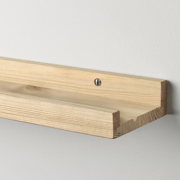 Shelf on light pine wall.