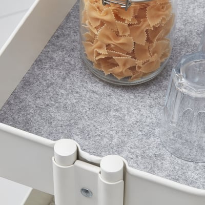 Countertop mat with non-slip backing under glass container and cup.