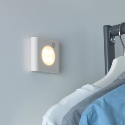 Wall-mounted light sensor activates automatically when motion detected. Light illuminates area efficiently, switching off when no movement is present.