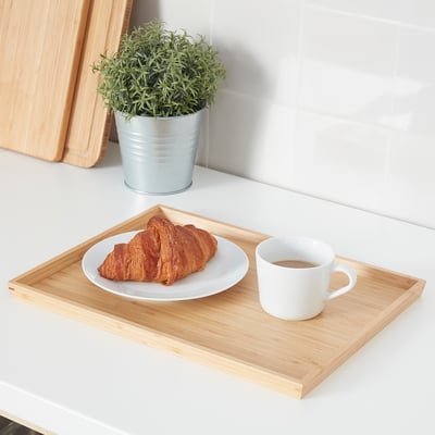 Bamboo serving tray with pastry and coffee.