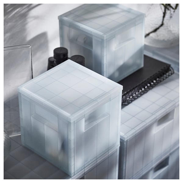Clear plastic organising boxes with blue grid, stacked, dust protection lid, recessed handles.
