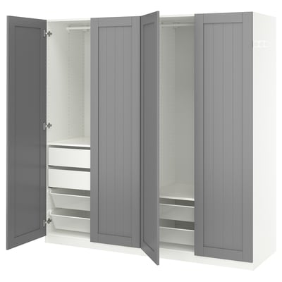 A grey PAX wardrobe with open doors, revealing shelves and drawers.