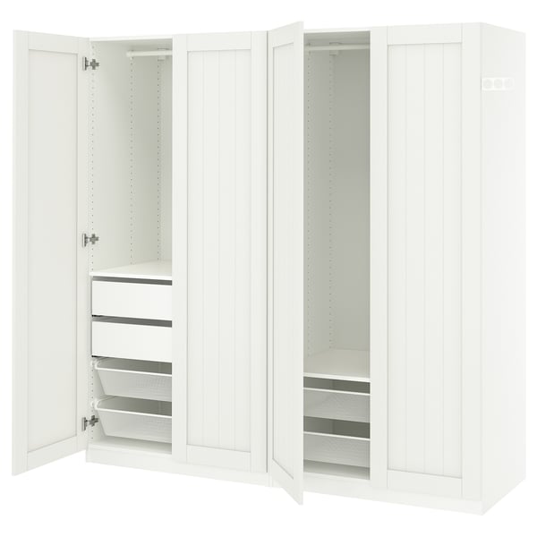 A white PAX wardrobe with open doors, revealing storage compartments and mesh drawers inside.
