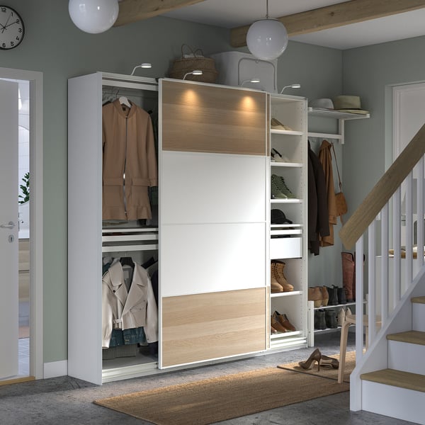 Modern wardrobe with sliding doors, beige and white, wooden and metallic elements, integrated lighting, and storage shelves.